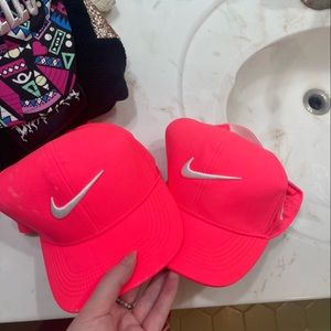 2 neon pink Nike golf hats
